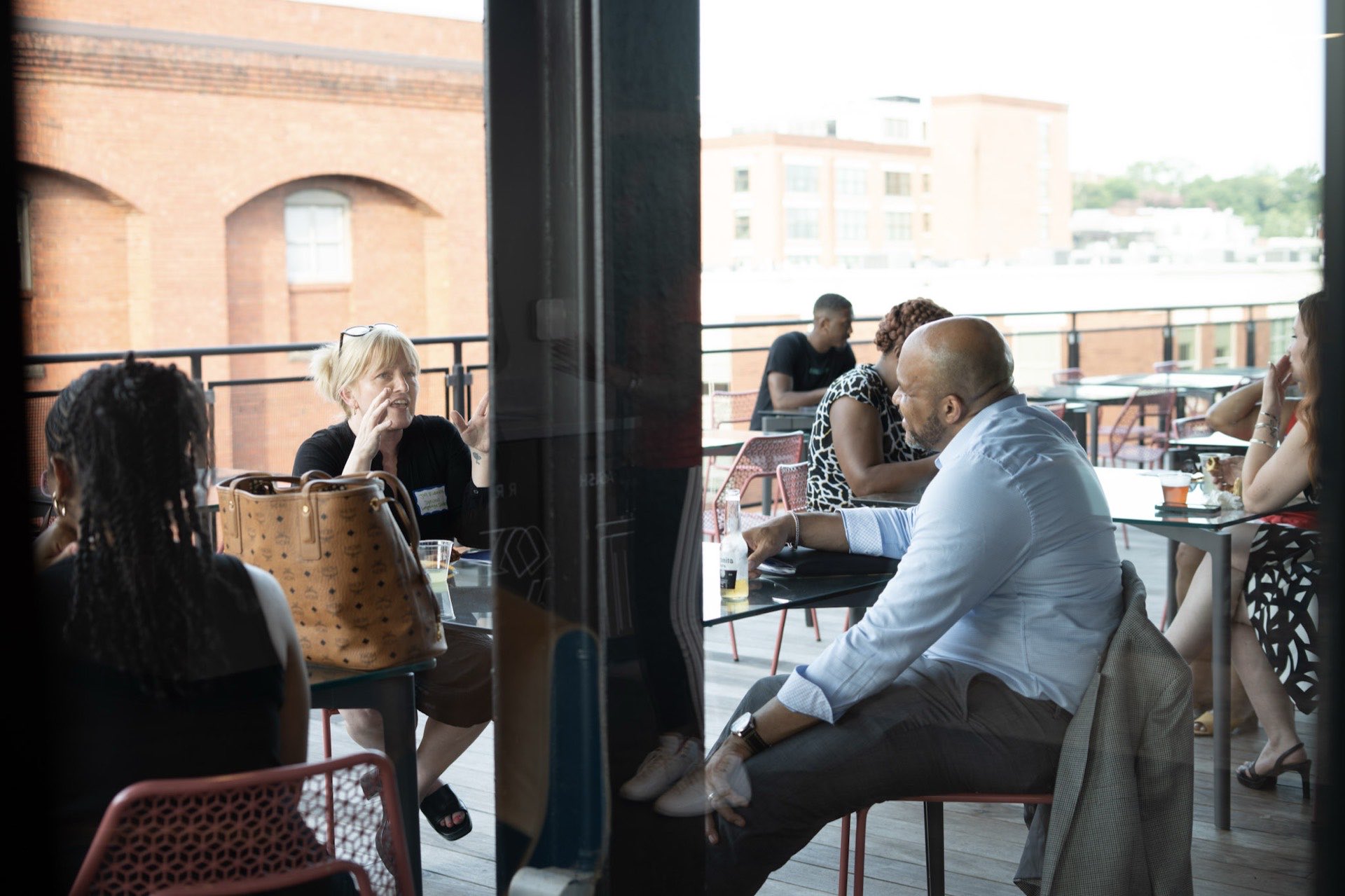 Founders connecting at a rooftop gathering overlooking Richmond